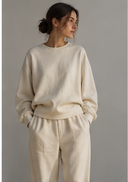 Woman in undyed natural cotton sweatshirt and trousers